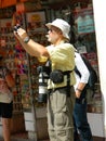 Professional photographer, old man, hanging large lens around hi