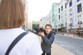 Professional photographer photographs the model on the street and talking to her Royalty Free Stock Photo