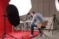 Professional photographer taking picture of expensive wristwatches in studio