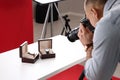 Professional photographer taking picture of expensive wristwatches in studio, focus on accessories