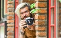 Professional photographer use vintage camera. Photography business. Bearded man hipster take photo. Modern business Royalty Free Stock Photo