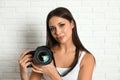 Professional photographer working near white wall in studio Royalty Free Stock Photo