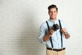 Professional photographer working near white wall in studio. Space for text Royalty Free Stock Photo