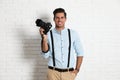 Professional photographer working near white wall in studio Royalty Free Stock Photo