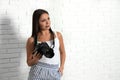 Professional photographer working near white wall in studio. Space for text Royalty Free Stock Photo