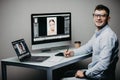Professional photographer works in photo editing app software on his personal computer. Photo editor retouching photos of Royalty Free Stock Photo
