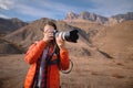 A professional photographer and a young attractive woman with a backpack and a professional camera in her hands takes a Royalty Free Stock Photo