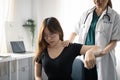 Physiotherapist helps patient doing rehabilitative physiotherapy in clinic. Royalty Free Stock Photo