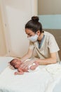 Professional physiotherapist performing mediastinal work on a newborn baby.