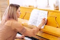 Professional pianist arranging music on piano