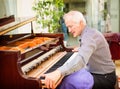 Professional piano technician removing keyboard for tuning repai Royalty Free Stock Photo