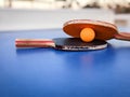 Professional ping pong rackets on a vibrant blue ping pong table, ready for game play Royalty Free Stock Photo