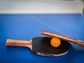 Professional ping pong rackets on a vibrant blue ping pong table, ready for game play Royalty Free Stock Photo