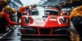 Professional pit crew ready for action as their team\'s race car arrives in the pit lane during a pitstop