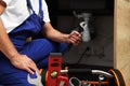 Professional plumber with adjustable wrench under kitchen sink, closeup Royalty Free Stock Photo