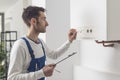 Professional plumber checking a boiler control panel Royalty Free Stock Photo