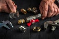 Professional plumber connects brass fittings with an adjustable wrench. Close-up of hand of the master during work in workshop Royalty Free Stock Photo