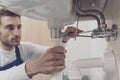 Plumber fixing a sink at home Royalty Free Stock Photo