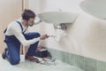 Plumber fixing a sink at home Royalty Free Stock Photo