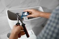 Professional plumber repairing toilet in bathroom, closeup Royalty Free Stock Photo