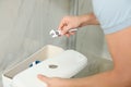 Professional plumber repairing toilet in bathroom Royalty Free Stock Photo