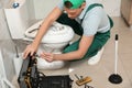 Professional plumber repairing toilet tank