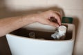 Professional plumber repairing toilet tank indoors Royalty Free Stock Photo