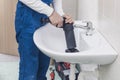 Professional plumber unclogging a sink Royalty Free Stock Photo