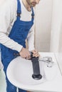 Professional plumber unclogging a sink Royalty Free Stock Photo