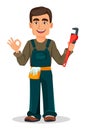 Professional plumber in uniform holds adjustable wrench and shows ok sign.