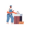 Professional plumber in uniform using spanner repairing sink cleaning repair service concept