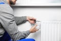 Professional plumber using pliers while preparing heating radiator for winter season, closeup Royalty Free Stock Photo