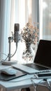 Professional podcast studio setup with a microphone and laptop on a clean white desk Royalty Free Stock Photo