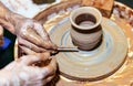 Professional potter makes a pot on a pottery wheel and teaches a pupil. Hands of a potter Royalty Free Stock Photo