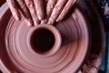 Professional potter making bowl in pottery workshop, studio