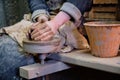 Professional potter making bowl in pottery workshop, studio