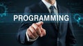 Professional Programmer Pointing to Programming Text with Gears and Code Background Depicting Technology Royalty Free Stock Photo