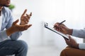 Professional psychological help concept. Unrecognizable black man talking to psychotherapist at office, closeup view Royalty Free Stock Photo