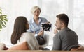 Professional Psychologist Showing Inkblot Picture Testing Couple Sitting In Office