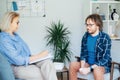 Professional psychotherapy. Female psychologist having session with male patient at mental health clinic, Taking Note Royalty Free Stock Photo