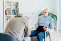 Professional psychotherapy. Male psychologist having session with male patient at mental health clinic, Taking Notes Royalty Free Stock Photo