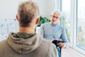 Professional psychotherapy. Male psychologist having session with male patient at mental health clinic, Taking Notes Royalty Free Stock Photo