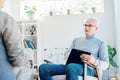 Professional psychotherapy. Male psychologist having session with male patient at mental health clinic, Taking Notes Royalty Free Stock Photo