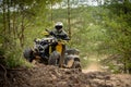 Professional quad biker rides in forest. Quad racing, ATV 4x4 Royalty Free Stock Photo