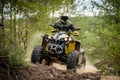 Professional quad biker rides in forest. Quad racing, ATV 4x4 Royalty Free Stock Photo