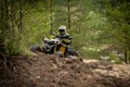 Professional quad biker rides in forest. Quad racing, ATV 4x4 Royalty Free Stock Photo