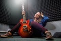 Professional recording Studio music recording. Musician woman sitting with a red electric guitar in the recording Studio. Girl Royalty Free Stock Photo