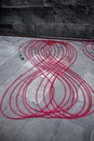 Professional red data transmission cables, on the sidewalk of the street. Royalty Free Stock Photo