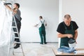 renovation crew painting walls of new build apartment Royalty Free Stock Photo