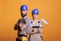 Professional renovators posing with painting tools Royalty Free Stock Photo